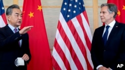 U.S. Secretary of State Antony Blinken, right, and China's Foreign Minister Wang Yi attend a meeting in Nusa Dua on the Indonesian resort island of Bali Saturday, July 9, 2022. 