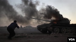 Sebuah tank pemerintah Libya terkena tembakan serangan udara NATO (10/4).