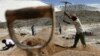 FILE - Workers try to start up an old metals mine in Uis, Namibia. Mining is the biggest contributor to Namibia’s gross domestic product.