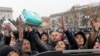 Kherson residents grab items from an aid supply distribution in the center of the city on Nov. 17, 2022.