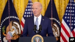FILE - President Joe Biden speaks in the East Room of the White House, in Washington, Feb. 23, 2024. Biden says he will convene the top four congressional leaders at the White House on Feb. 27, 2024.