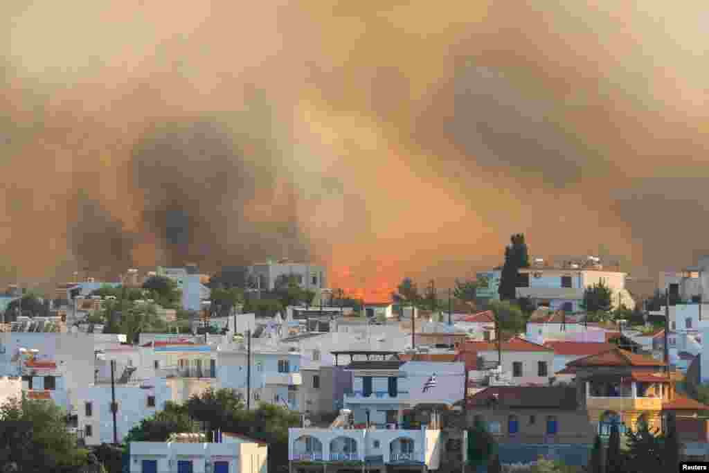 Flames and smoke rise as a wildfire burns near the village of Gennadi, on the island of Rhodes, Greece, July 25, 2023. 