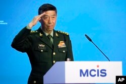 FILE - Chinese Defense Minister Li Shangfu salutes as he arrives to deliver his speech in Moscow, Russia, Aug. 15, 2023. Li has not been seen in public since August 25.