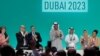 Le président de la COP28, Sultan Ahmed Al Jaber (centre), applaudit parmi d'autres responsables à la COP28 à Dubaï le 13 décembre 2023.