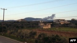 A handout image released March 12, 2023, by the official Syrian Arab News Agency (SANA) shows smoke billowing from a site Damascus says was targeted by Israeli airstrikes, in Masyaf, in Syria's central Hama countryside.