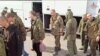 Sebuah gambar yang dirilis oleh Kementerian Pertahanan Rusia, menunjukkan sejumlah personel militer Rusia yang naik bus pasca pertukaran tawanan perang di lokasi yang tidak diketahui, diambil dari rekaman video yang dirilis Senin, 10 April 2023.