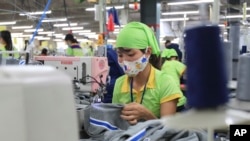 FILE - A worker sews a garment at a factory in Nam Dinh province, Vietnam, Oct. 24, 2017. 
