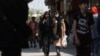 Iranian women walk on a street amid the implementation of the hijab surveillance in Tehran, Iran, April 15, 2023. Majid Asgaripour/West Asia News Agency via Reuters