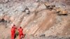 In this photo released by China's Xinhua News Agency, rescuers work at the site of a collapsed open pit coal mine in Alxa Banner in northern China's Inner Mongolia Autonomous Region, Feb. 24, 2023.