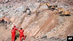 In this photo released by China's Xinhua News Agency, rescuers work at the site of a collapsed open pit coal mine in Alxa Banner in northern China's Inner Mongolia Autonomous Region, Feb. 24, 2023.