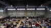 FILE - Ukrainian refugees wait in a gymnasium Tuesday, April 5, 2022, in Tijuana, Mexico.