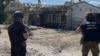In this handout photograph taken and released by the Office of the Prosecutor General of Ukraine on Aug. 26, 2023, war crime prosecutors work at the site of a shelling in the village of Podoly near Kupiansk, Kharkiv region.
