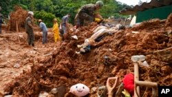 Children's toys lie in the mud where rescue workers look for bodies after a deadly landslide was triggered by heavy rains near Barra do Sahi beach in the coastal city of Sao Sebastiao, Brazil, Feb. 22, 2023. 