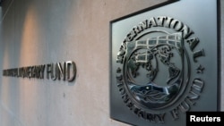 FILE - The International Monetary Fund logo is posted the headquarters building in Washington, Sept. 4, 2018. 