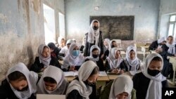 FILE - Afghan school girls in class on the first day of the new school year in Kabul, March 25, 2023. Though Afghanistan's new school year had started, high schools remained closed to girls for the second year since the Taliban returned to power.