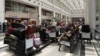 People sit near their luggage at the Beirut–Rafic Hariri International Airport, in Beirut, Lebanon, July 29, 2024.