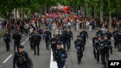 Anti-riot police officers walk ahead of an anti far-right rally in Toulouse after French president called legislative elections following far-right parties' gains in European Parliament elections, June 15, 2024.