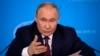 FILE - Russian President Vladimir Putin speaks at the Russian Foreign Ministry in Moscow, June 14, 2024. President Joe Biden has vowed to support Ukraine in its war with Russia “as long as it takes,” but former President Donald Trump's view of the conflict is complicated.