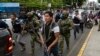 Soldiers and police provide security behind an armored vehicle as supporters of presidential candidate Daniel Noboa, of the National Democratic Action Alliance political party, attend a rally with their candidate in downtown Esmeraldas, Ecuador, Oct. 6, 2023. 