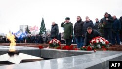 FILE - Mourners gather to lay flowers in memory of more than 60 Russian soldiers that Russia says were killed in a Ukrainian strike on Russian-controlled territory, in Samara, Russia, Jan. 3, 2023.
