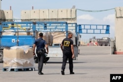 Trucks carrying humanitarian aid slated for Gaza await clearance at the Kerem Shalom (Karm Abu Salem) border crossing on March 14, 2024 amid the ongoing conflict between Israel and the Palestinian militant group Hamas.