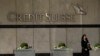 Seorang wanita berjalan melewati kantor pusat bank Credit Suisse di London, Kamis, 16 Maret 2023. (Foto: Frank Augstein/AP)