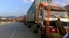 FILE - Stranded trucks loaded with supplies for Afghanistan, line up on a highway at the key border crossing point of Torkham in Pakistan along the Afghan border, Feb. 21, 2023. The border crossing has since reopened.