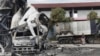 FILE - A Thai officer stands beside a burned-out oil tanker at a gas station in Pattani province, southern Thailand, Aug. 17, 2022. Thailand’s southernmost provinces have been the scene of an active Muslim separatist insurgency for almost two decades. 