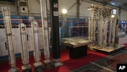 FILE - Iran's domestically built centrifuges are displayed at an exhibition of the country's nuclear achievements, in Tehran, Feb. 8, 2023. 