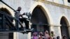 FILE - A cameraman films a scene from a crane during the making of "Ake," a film based on the childhood memoirs of Nigerian writer Wole Soyinka, in Abeokuta, southwest Nigeria, July 14, 2013. Nigeria's movie business, often known as Nollywood, is one of the biggest in the world.