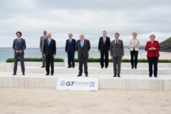 Leaders of the G7 pose for a group photo on overlooking the beach at the Carbis Bay Hotel in Carbis Bay, St. Ives, Cornwall, England, June 11, 2021.