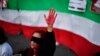 A woman raises her hand with red paint during a demonstration in support of Iranian women on Oct. 4, 2022, in Barcelona following the death of Kurdish Iranian woman Mahsa Amini in Iran.