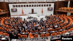 FILE - Main opposition Republican People's Party lawmakers hold placards as they protest against a media bill at the Turkish Parliament in Ankara, Oct. 4, 2022. Lawmakers approved the bill Oct. 13.