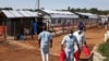 Medical attendants walk outside the Ebola isolation section of Mubende Regional Referral Hospital, in Mubende, Uganda, Sept. 29, 2022.
