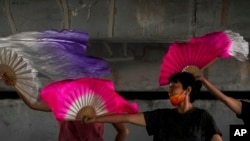 Beijing residents find refuge under a bridge and try to cool off on July 21, 2022, as China faces extreme heat as well as a rare tornado the day before. 