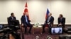 This handout photo taken and released on July 19, 2022, shows Turkish President Recep Tayyip Erdogan (2-L) talking with Russian President Vladimir Putin during a meeting as part of the Astana Trilateral Summit in Tehran, Iran. (Turkish Presidential Press Service)