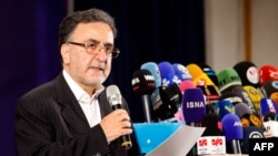 FILES - Iranian reformist politician Mostafa Tajzadeh speaks to the media after registering his candidacy at the Interior Ministry in the capital Tehran, for the Islamic Republic's upcoming presidential elections, May 14, 2021.