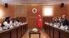 FILE - Turkish Foreign Minister Mevlut Cavusoglu, right, and Amir Khan Muttaqi, the acting foreign minister, of Afghanistan, left, speak during a meeting, in Ankara, Turkey, Thursday, Oct. 14, 2021. 