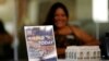 FILE - A hiring sign is placed at a booth for prospective employers during a job fair Sept. 22, 2021, in the West Hollywood section of Los Angeles. 