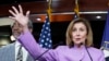 House Speaker Nancy Pelosi of California speaks as Rep. Gregory Meeks, D-N.Y., listens during a news conference on Capitol Hill, Aug. 10, 2022, in Washington. 