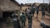 Patriotic Front for Peace/People's Army militiamen, one of the largest armed groups in North Kivu, led by self-proclaimed general Kabido, walk around their headquarters in Mbwavinwa, Lubero territory, eastern Democratic Republic of Congo on May 5, 2024. (ALEXIS HUGUET / AFP)
