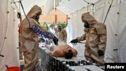 Members of the State Emergency Service attend nuclear disaster response drills amid shelling of Zaporizhzhia Nuclear Power Plant, in Zaporizhzhia, Ukraine August 17, 2022.