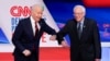 Mantan wakil presiden AS Joe Biden (kiri) dan Senator Bernie Sanders (kanan) saling menyapa sebelum debat Pilpres 2020 di Studio CNN di Washington, Minggu, 15 Maret 2020. (Foto: AP)