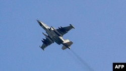 FILE - A Russian air force Sukhoi-25 fighter jet flying over the Syrian city of Saraqib, southwest of Aleppo, Feb. 1, 2018.