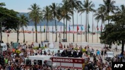 Fans of the late Brazilian football star Pele gather on the street as a firetruck transports Pele's coffin to the Santos' Memorial Cemetery in Santos, Sao Paulo state, Brazil on January 3, 2023.