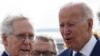 U.S. President Joe Biden is greeted by Senate Republican Leader Mitch McConnell (R-KY) and Ohio Governor Mike DeWine as he arrives at Cincinnati Northern Kentucky Airport in Hebron, Kentucky, U.S., January 4, 2023.