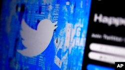 FILE - The Twitter splash page is seen on a digital device, April 25, 2022, in San Diego. European Union data show that Twitter took longer to review hateful content and removed less of it in 2022 compared with the previous year. 