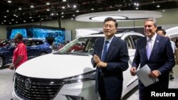 FILE - Chinese Ambassador to the US Qin Gang (left) at the North American International Auto Show in Detroit, Michigan, Sept. 14, 2022.