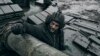 A Ukrainian soldier looks out of a captured Russian tank on the front line in Ukraine's Donetsk region, Nov. 22, 2022.