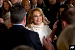 FILE - People applaud former Arizona Rep. Gabby Giffords as she arrives in the East Room of the White House in Washington, to hear President Obama speak about steps his administration is taking to reduce gun violence, Jan. 5, 2016.